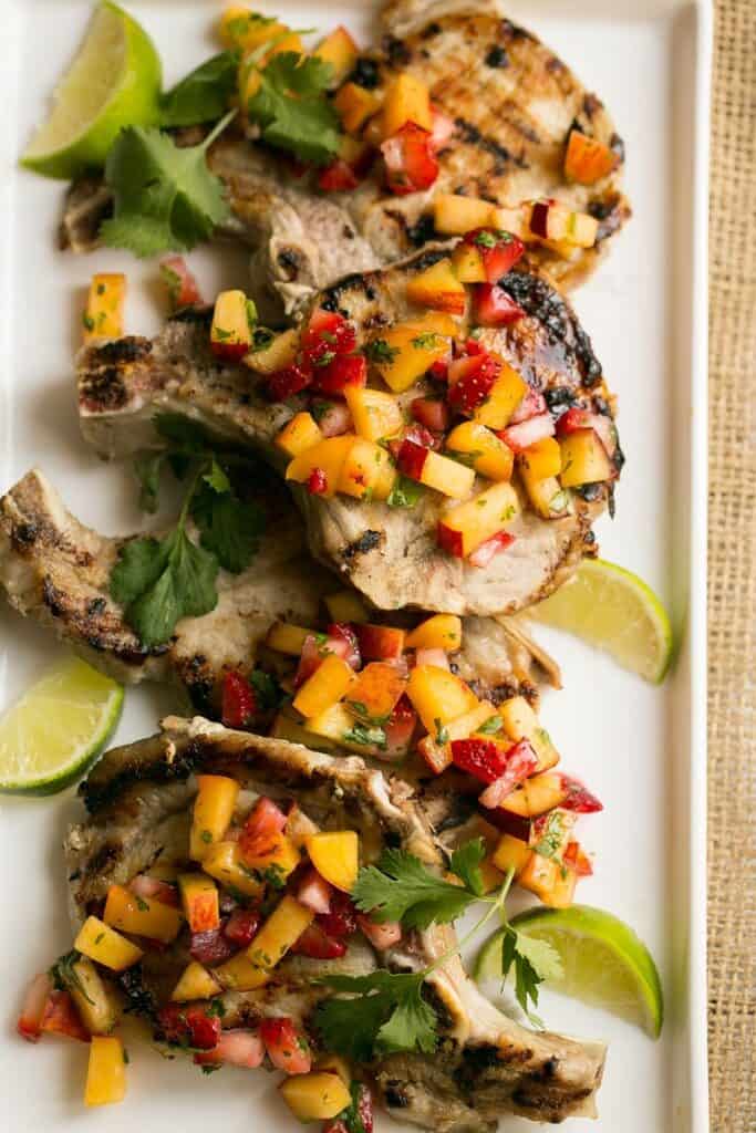 My contributor Sara is sharing her recipe for Pork Chops with Strawberry Peach Salsa- Love, Pasta and a Tool Belt | recipes | dinner | grill | grilling | recipe ideas | pork chops | salsa |