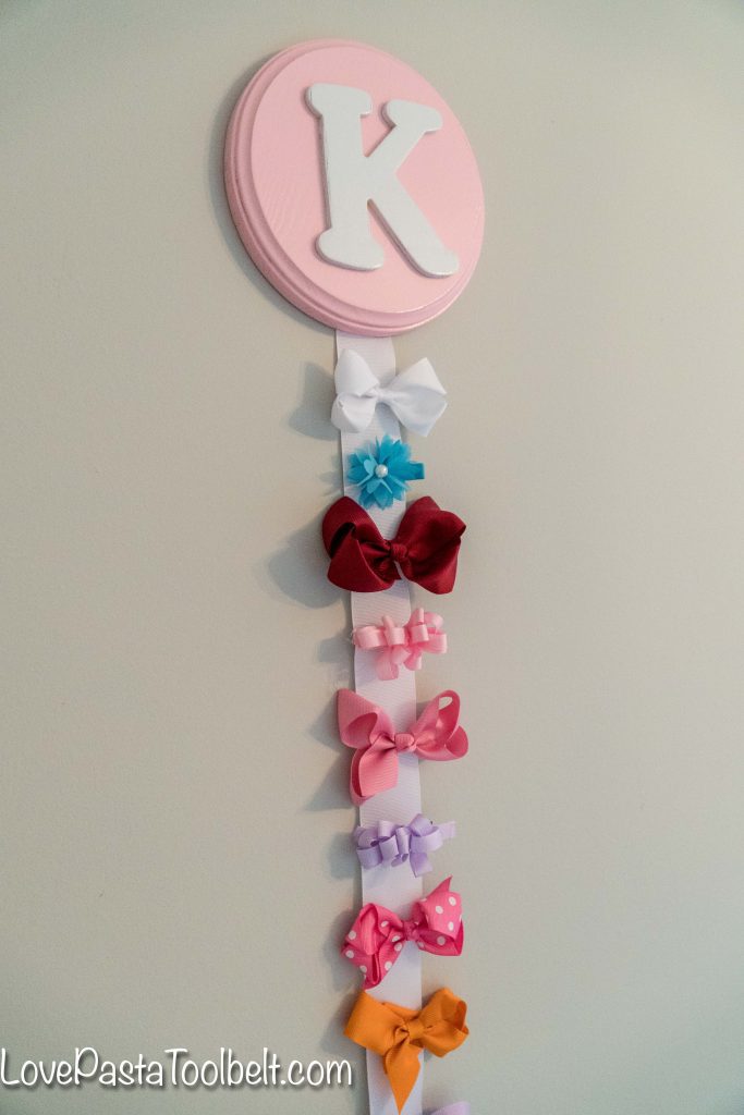 Create a cute and functional way to display your little girl's bows with this DIY Bow Holder