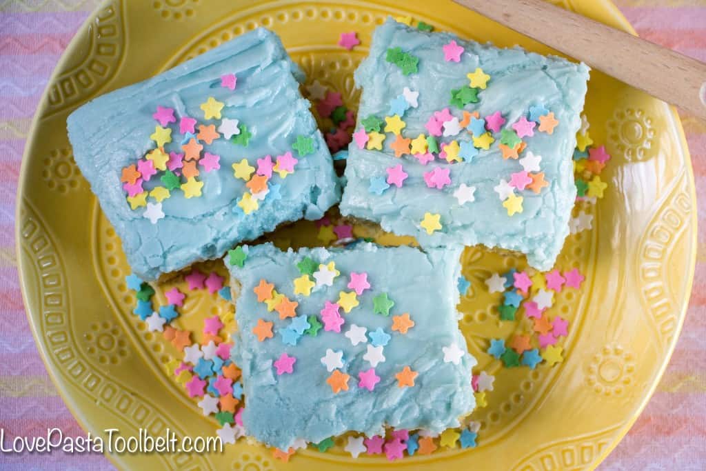 Thick, delicious and covered in frosting, these Sugar Cookie Bars will be your new favorite dessert!- Love, Pasta and a Tool Belt | desserts | Easter | dessert recipes | sweets | 